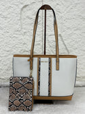 White tote bag with brown handles and trim, and a snake print phone case on a textured white background.